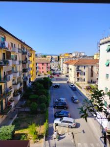 a city street with parked cars and buildings at B&B Comfort Room 93 in Benevento