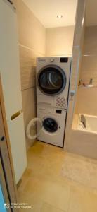 a washer and dryer in a small room at Appartement de Luxe à Torcy in Torcy +2 photos
