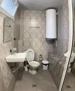 a bathroom with a toilet and a sink at Вила Оазис Сарай - Царево in Tsarevo +52 photos