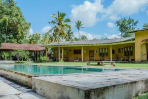a house with a swimming pool in front of it at Rivendell Twisted Tree in Kurunegala