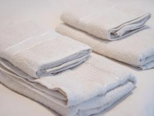 a pile of white towels sitting on a table at Casuta bunicilor in Volovăţ +59 photos