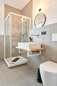 a bathroom with a shower and a sink and a toilet at Alte Seifensiederei - Thay in Bad Tölz