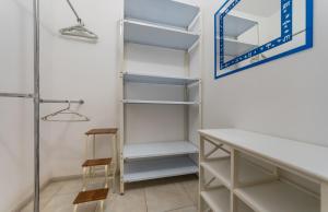 a closet with white shelves and a mirror at Люкс Армянская 6 ,метро 5 минут ходьбы in Kyiv +6 photos