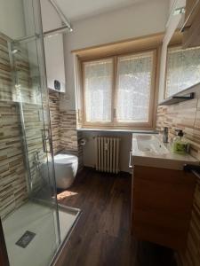 a bathroom with a shower and a sink and a toilet at Paradiso delle Nevi in Sestriere +18 photos
