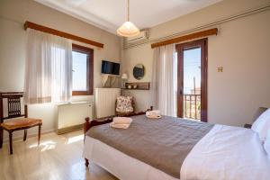 a bedroom with a large bed and a window at Ilia house in Volos