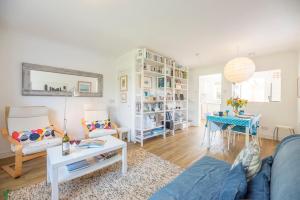 a living room with a couch and a table at Chestnutt Cottage, Reydon in Reydon