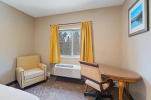 a room with a table and a chair and a window at Wagon Wheel Hotel in West Yellowstone