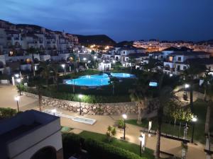 a view of a pool in a city at night at RELAX en Vera Playa con SPA con Ventiladores de techo y aire acondicionado in Vera +48 photos