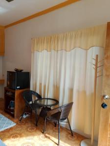 a room with a table and two chairs and a window at Japitan Waterfront Resort in Dolores