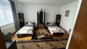 a room with two beds and a table in it at MZ Apartment in Trenčín