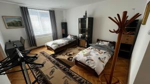 a bedroom with two beds and a dresser in it at MZ Apartment in Trenčín