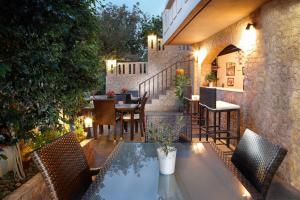 a patio with a table and chairs and a restaurant at Sun Nicolas in Kato Daratso