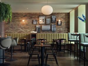 a restaurant with tables and chairs and a brick wall at Townhouse Hotel Maastricht & Spa in Maastricht