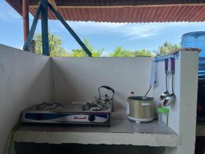 a stove top oven sitting on top of a counter at Zia's homestay-2 in Siquijor