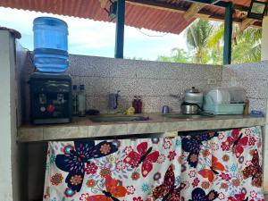 a kitchen with a counter top with a sink at Zia's homestay-2 in Siquijor