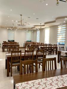 a dining room filled with wooden tables and chairs at Hotel 81 in Međugorje +23 photos