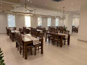 a restaurant with wooden tables and chairs and windows at Hotel 81 in Međugorje