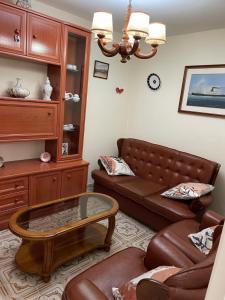 a living room with a couch and a coffee table at Acogedora casa a pie de playa in Cillero