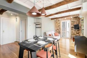 a dining room with a table and chairs in a living room at Lover's Lane 1, TerreMarine in Riomaggiore