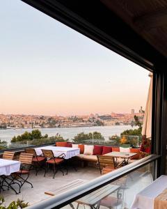 a view from the balcony of a restaurant with tables and chairs at Istanbul Old City Colorful Houses Balat PETRION Hotel in Istanbul