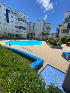 a swimming pool in the middle of a building at appartement pour vacances avec piscine in Bouznika