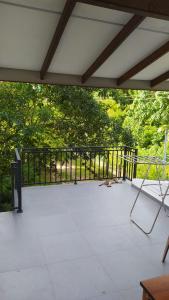 a patio with a fence and a table and chairs at Villa 142 in Weligama
