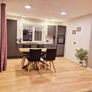 a kitchen and dining room with a table and chairs at Butas Ežero 30 in Plateliai