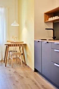 a kitchen with a table and a table and a chair at Alte Seifensiederei - Astrid in Bad Tölz