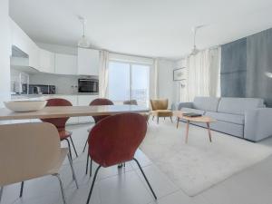 a kitchen and living room with a table and chairs at Appartements avec Terrasse - Cite du Vin in Bordeaux
