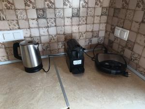 a room with a coffee maker and a toaster on the floor at Pezoulia Cottages in Samothraki