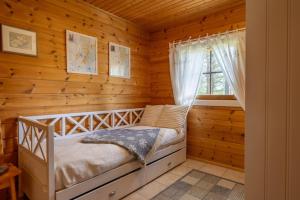 a bedroom with a bed in a log cabin at Rovankoto by Hi Ylläs in Ylläsjärvi
