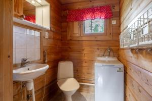 a bathroom with a toilet and a sink at Rovankoto by Hi Ylläs in Ylläsjärvi +12 photos