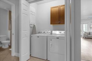 a white kitchen with a stove and a sink at 3 Bedrooms 2 Bathrooms Reunion 7521-104 Md in Kissimmee +21 photos