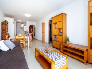 a living room with a couch and a table at Cozy Apartment Playa Paraiso, Pool in Playa Paraiso +22 photos