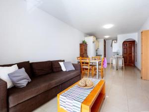 a living room with a couch and a table at Cozy Apartment Playa Paraiso, Pool in Playa Paraiso