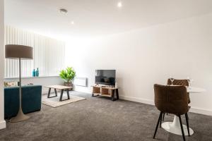 a living room with a couch and a table at Modern and Spacious Central Rotherham Studio in Rotherham