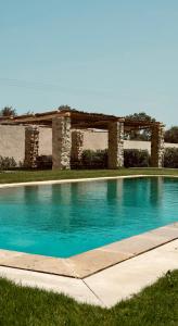 a swimming pool in front of a building at Domaine El Htouba in Korba +19 photos