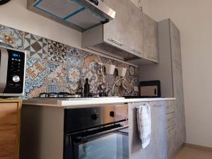 a kitchen with a stove and a counter top at Casa Margherita in Casa Santa