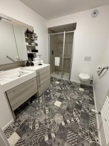 a bathroom with a sink and a toilet at DOMITYS - Nancy in Nancy +14 photos