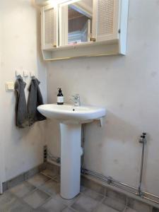 a bathroom with a white sink and a mirror at Private apartment in Innertavle in Umeå