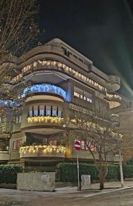 a large building with lights on it at night at Lux Beach Apartment BLACK in Lido di Ostia