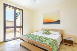 Postel nebo postele na pokoji v ubytování Oasi Kite - Stagnone Apartments