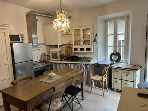 a kitchen with a wooden table and a dining room at Akasa on Lake Como in Menaggio