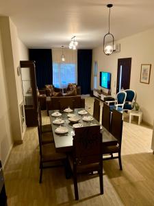 a dining room and living room with a table and chairs at KUBA LuXuS - VillA in Sahl hashesh-hurghada in Hurghada