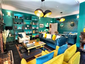 a living room with green walls and yellow furniture at Dunningwell Hall in Duddon