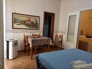 a room with a table and a room with a bed at Casa di Lia in Montelepre