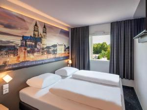 Postel nebo postele na pokoji v ubytování B&B HOTEL Magdeburg-Barleben