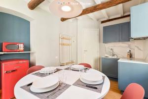 a kitchen with a white table and red refrigerator at Lover's Lane 2, TerreMarine in Riomaggiore
