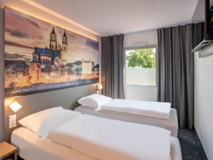 Postel nebo postele na pokoji v ubytování B&B HOTEL Magdeburg-Barleben
