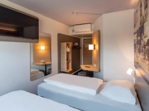 Postel nebo postele na pokoji v ubytování B&B HOTEL Magdeburg-Barleben
